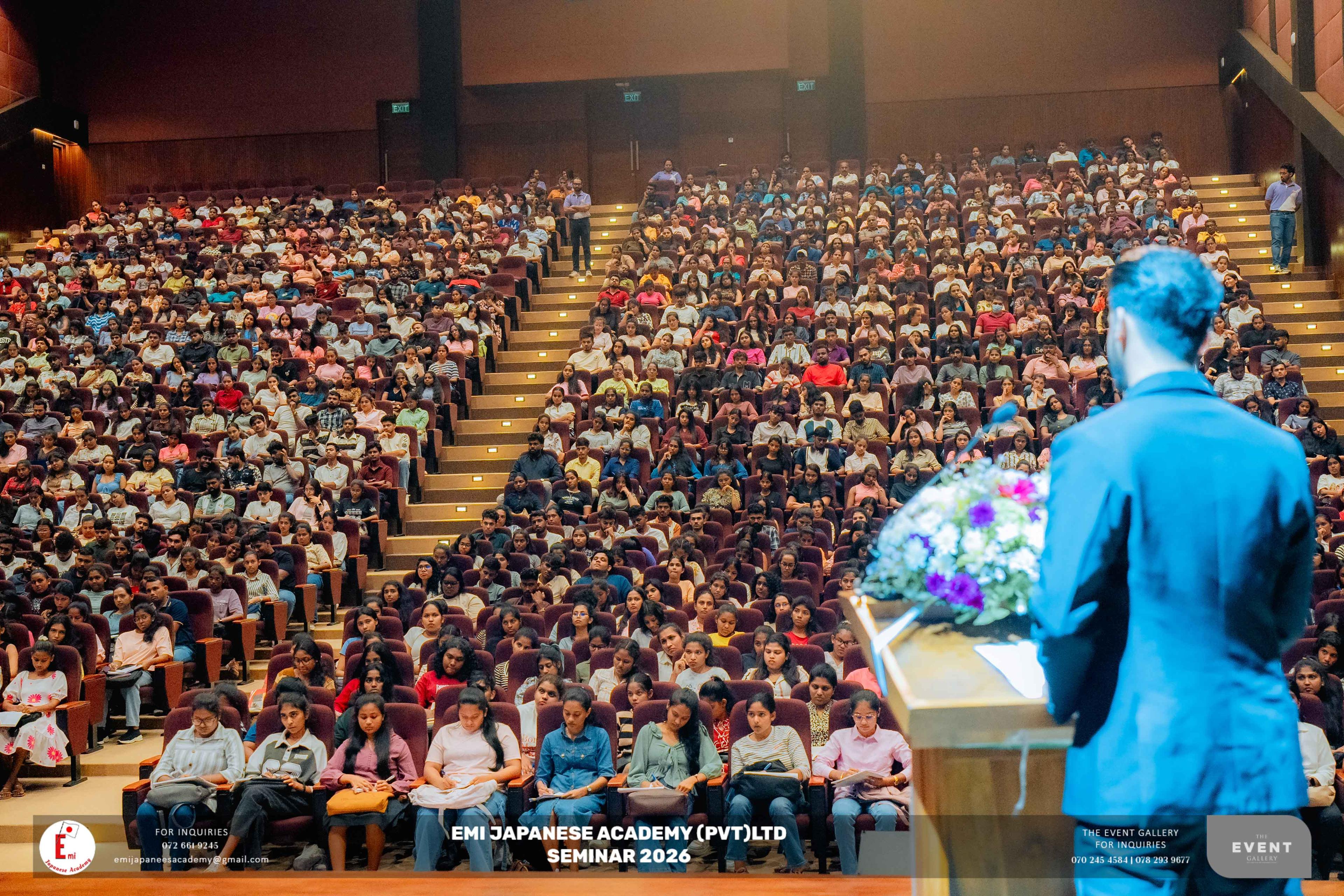 Speaker addressing a packed auditorium at a seminar